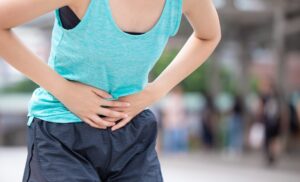 Endometriose / young sport woman painful stomachache. Chronic gastritis. Abdomen bloating concept. Women menstrual